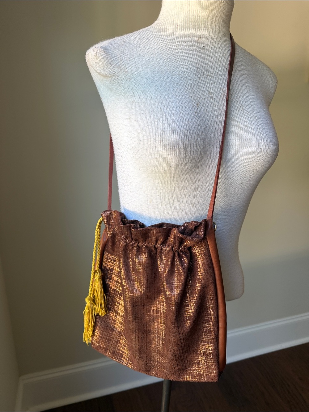Hand Crafted Brown Metallic Drawstring Shoulder Bag with Yellow Tassel Accent